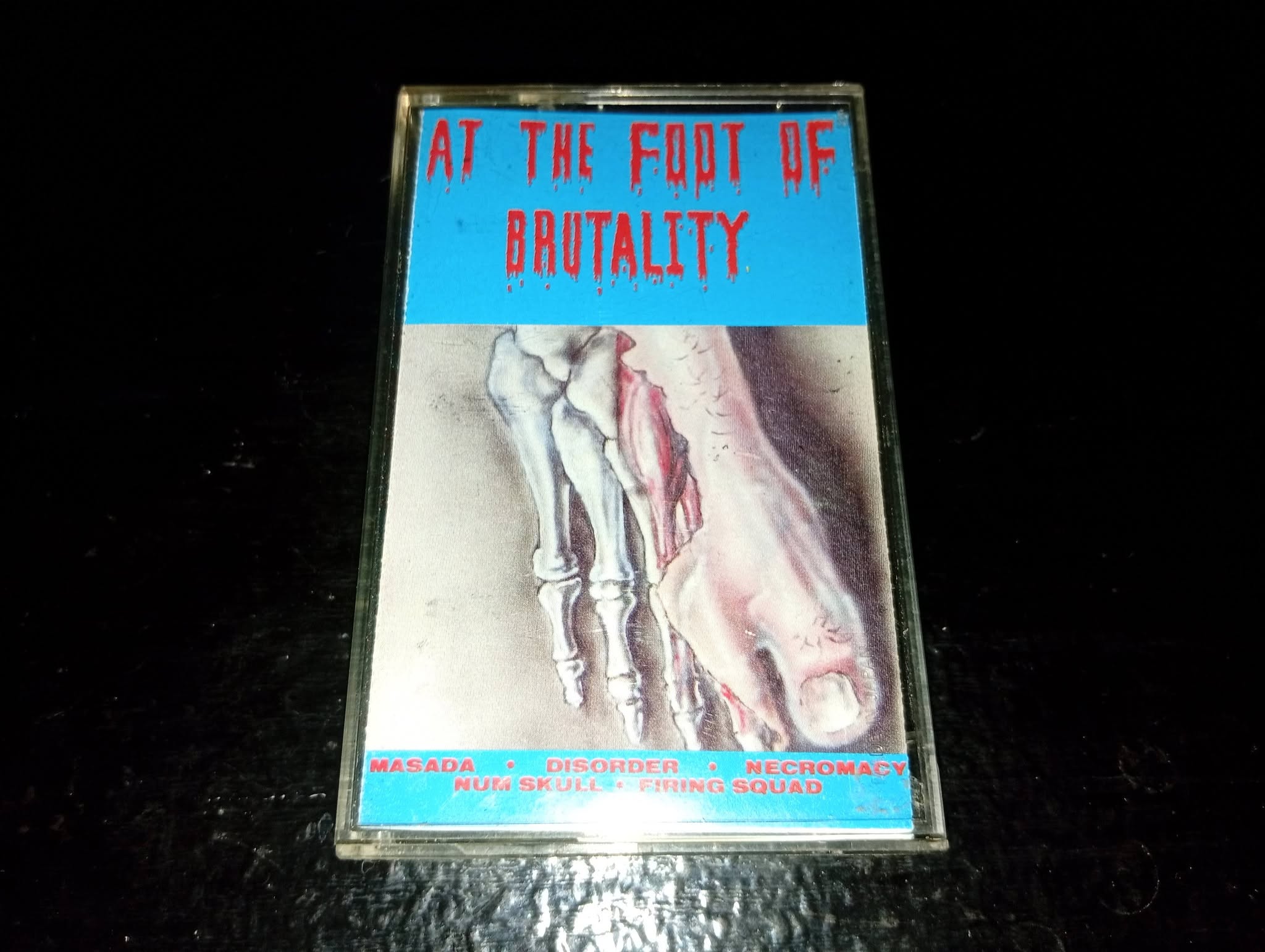 Various – At The Foot Of Brutality Cassette